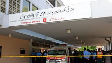 Police officers move past an ambulance outside an intensive care unit after a fire broke out at the Pakistan Institute of Medical Sciences (PIMS) hospital in Islamabad, Pakistan, August 26, 2026