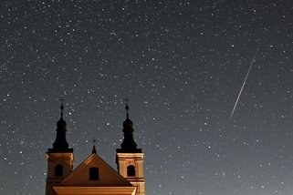 This long exposure picture shows a meteor crossing the night sky over the Post-Camaldolese monastery in the village of Wigry, Suwalki region, during the annual Perseids meteor shower early on August 12, 2024. (Photo by Sergei GAPON / AFP)