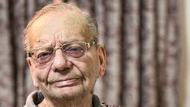 Author Ruskin Bond poses with his book 'All-Time Favourite Friendship Stories' during its launch event organised by Penguin India in collaboration with Book World, in Dehradun.