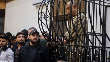 FILE -Atef Najib, former head of the Political Security Branch in the Daraa area during Bashar Assad's rule, sits in the defendants' cage during a trial session at the Palace of Justice in Damascus, Syria, April 26, 2026. (AP Photo/Ghaith Alsayed), File)