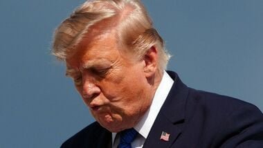 US President Donald Trump gestures while stepping off Air Force One upon arrival at Morristown Municipal Airport in Morristown, New Jersey, on July 31, 2026. (Photo by Aaron Schwartz / AFP)