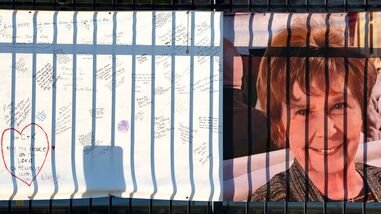 A banner with a growing collection of well-wishes from supporters reads 'bring her home' (not pictured) and shows a photo of Nancy Guthrie, the 84-year-old mother of U.S. journalist and television host Savannah Guthrie, who disappeared from her home nearly two weeks ago, outside of the KVOA newsroom in Tucson, Arizona, U.S., February 14, 2026.