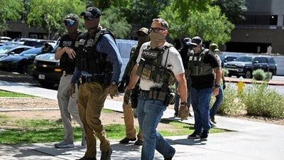 ICE agent pulls gun after Virginia woman confronts officers. (REUTERS)