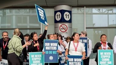 Flight attendants at Canada's WestJet hold placards while on strike after failing to reach a deal with the country's second-largest carrier, at Toronto’s Pearson Airport, in Mississauga, Canada, August 2, 2026.