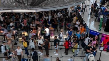 People wait in a security line at John F. Kennedy International Airport on August 12, 2026 in the Queens borough of New York City. Spencer Platt/Getty Images/AFP - Representative Image